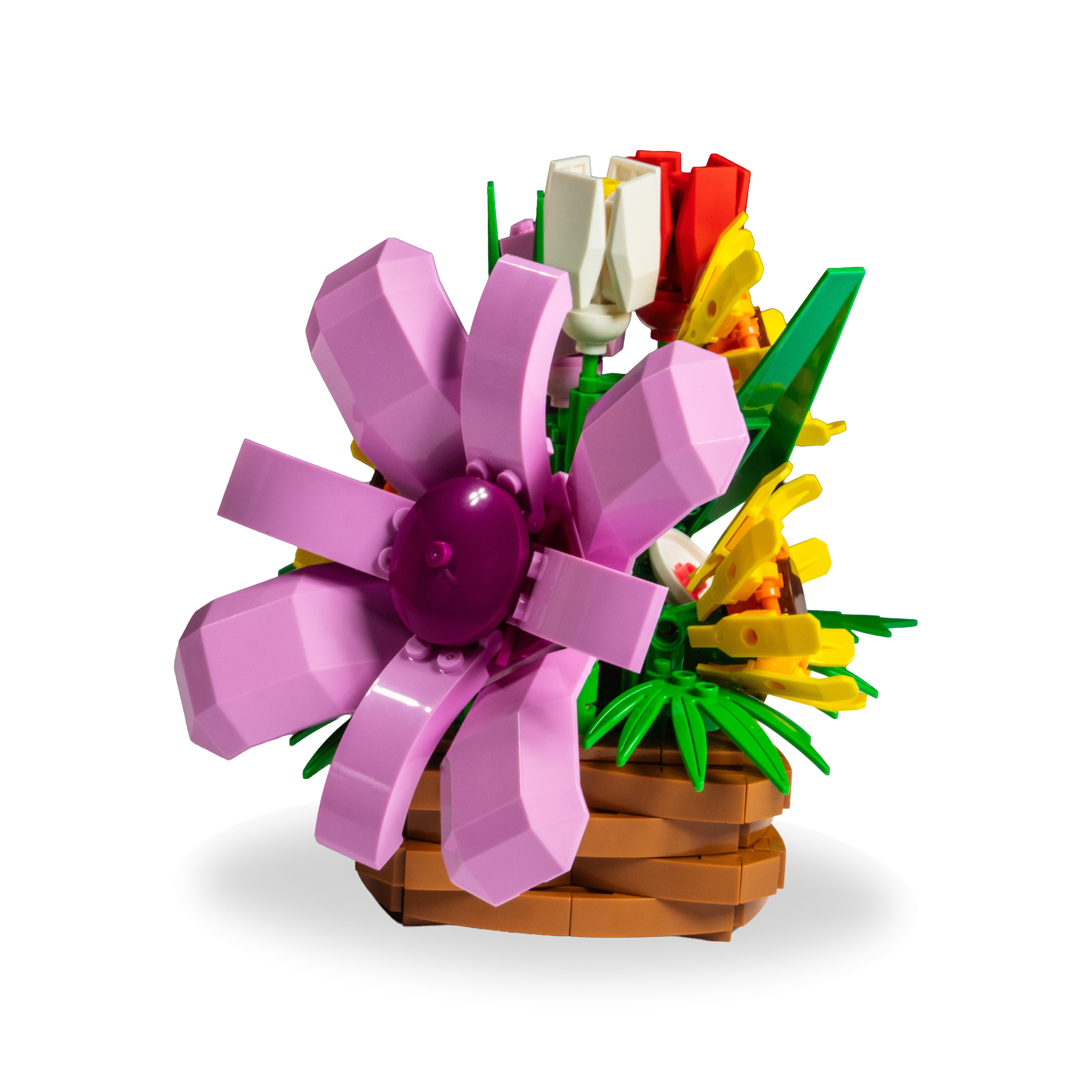 LEGO flower arrangement with a purple flower, white tulip, and yellow daffodil on a white background