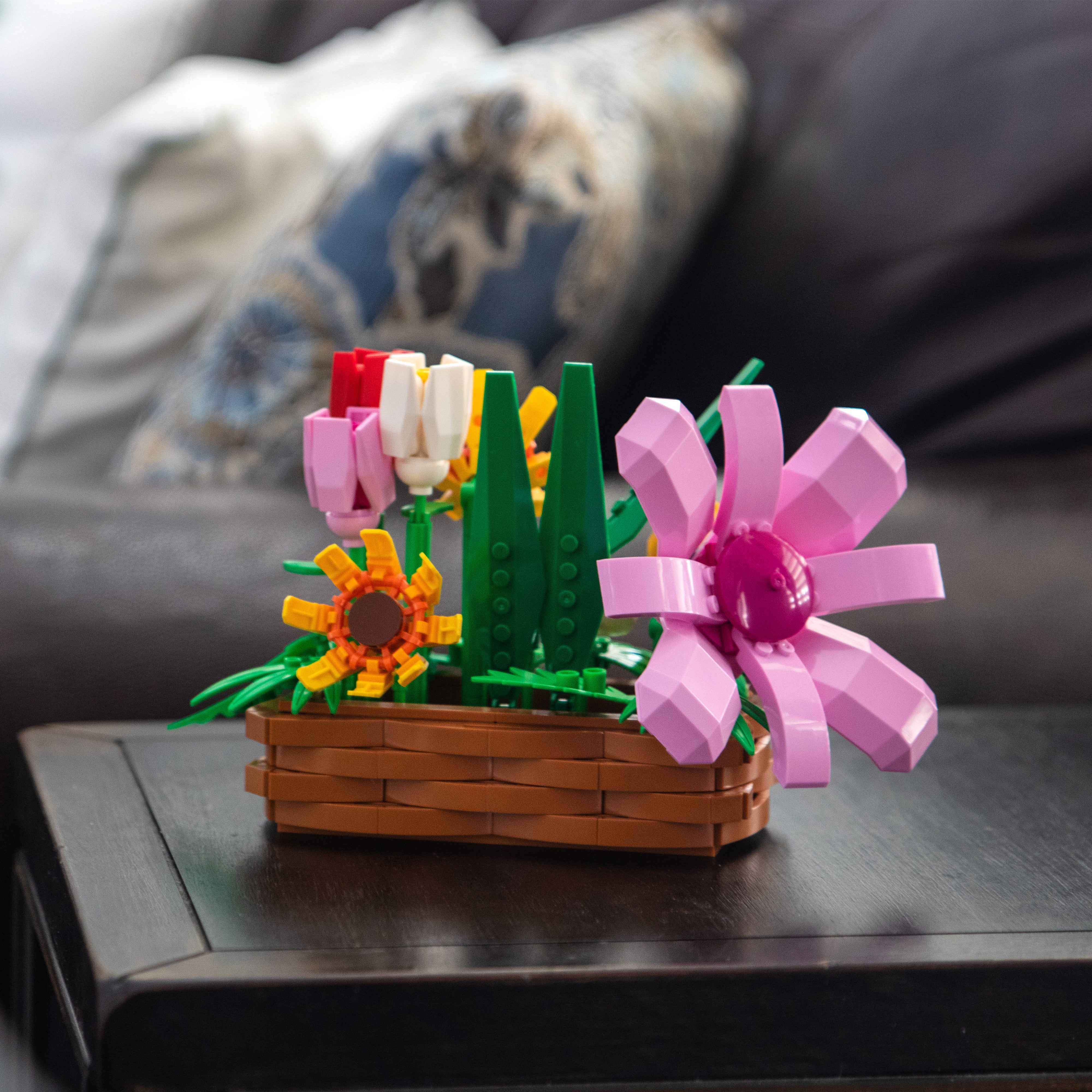 LEGO flower arrangement on a table with a blurred background