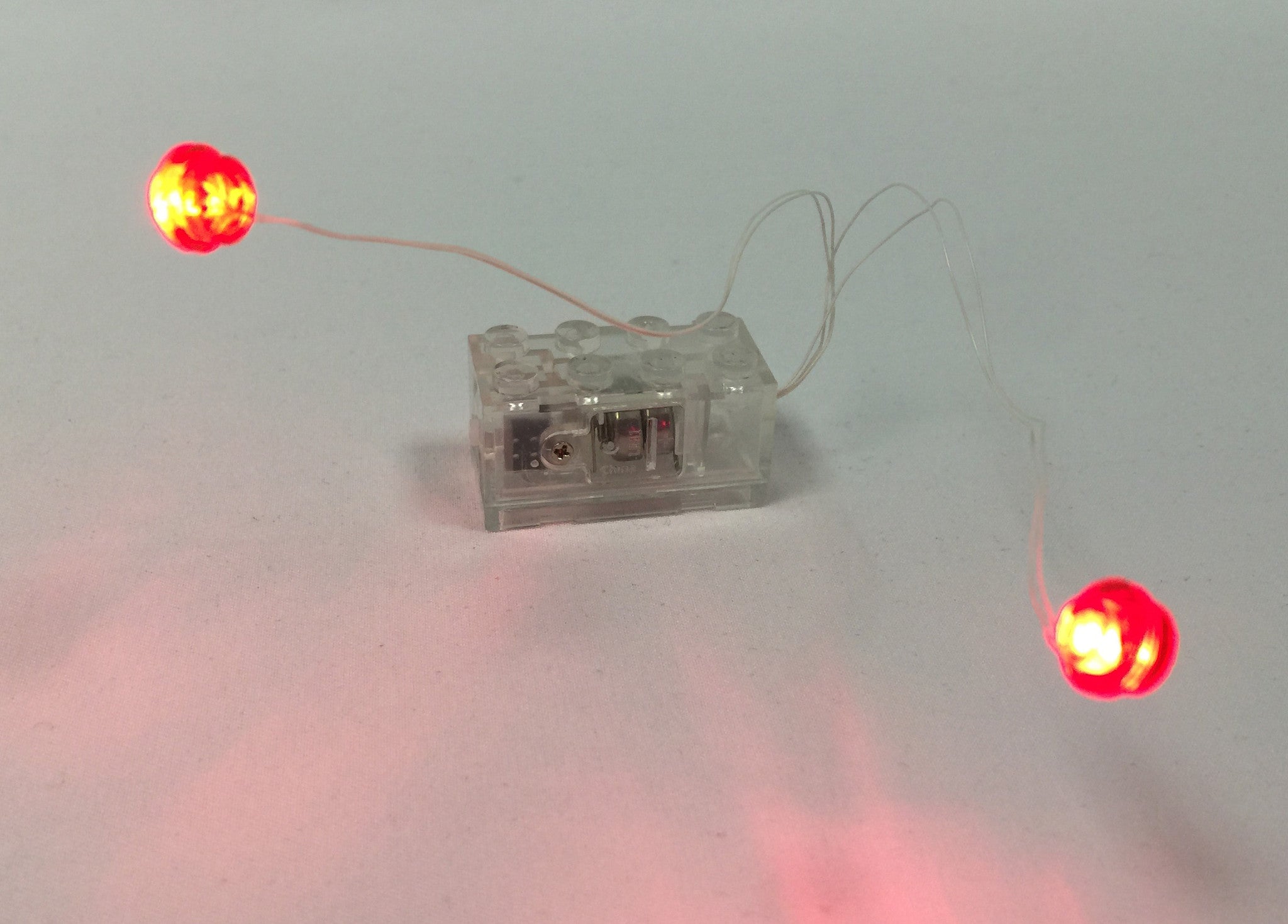 Brick Loot LED Light Kit Double Red LEGO studs with white wire powered by clear 2x4 battery brick (batteries included)