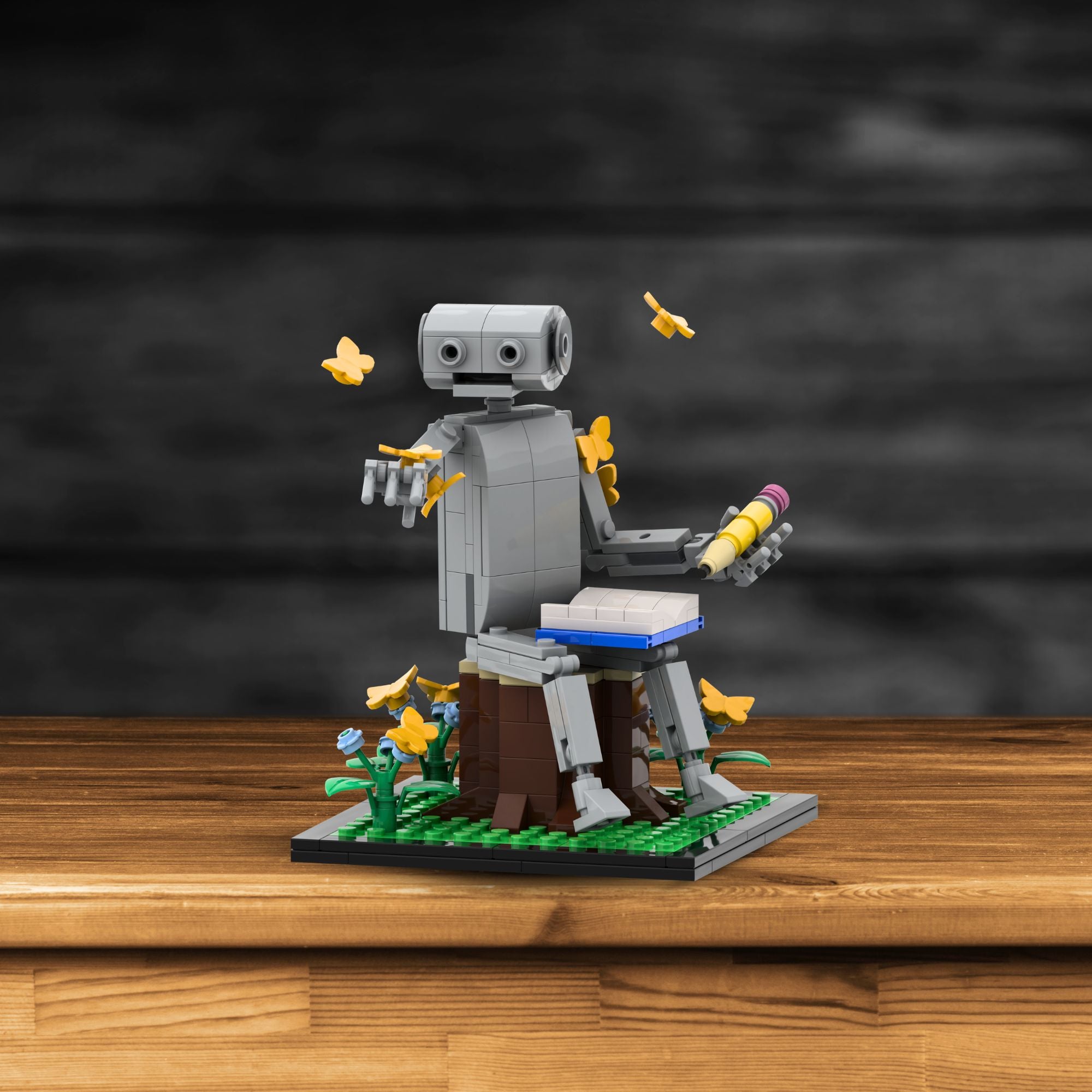 Limited edition LEGO robot set The Naturalist displayed on wood surface with pencil, book, and butterflies – ideal for collectors