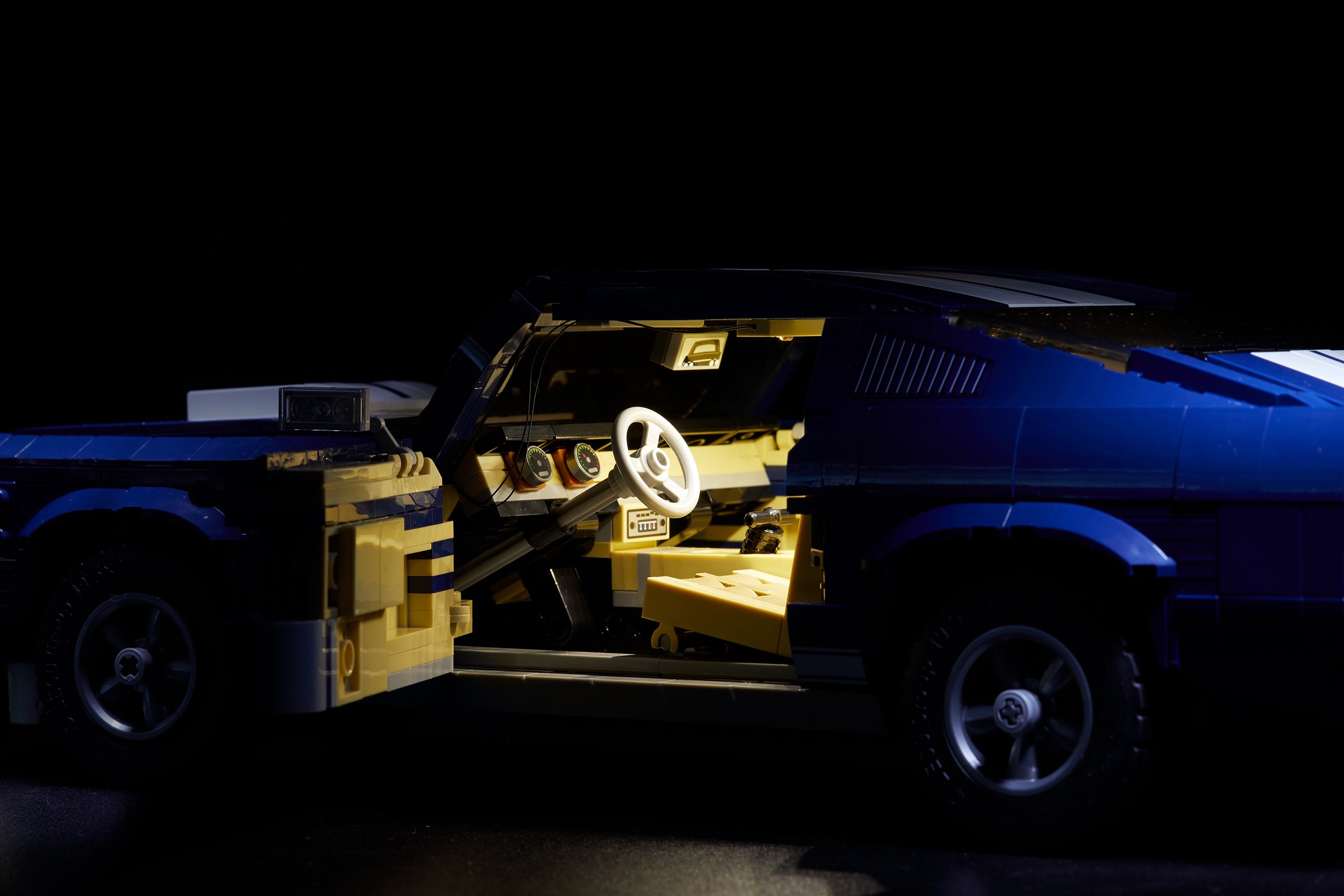 Close-up of the blue LEGO Ford Mustang set 10265, with the custom Brick Loot LED Light kit installed.
