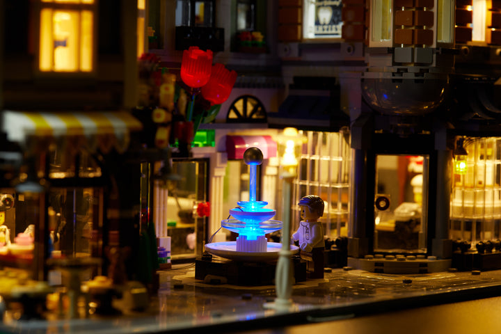 Close up of the fountain of the LEGO Assembly Square set 10255 with the Brick Loot LED Light Kit installed. Brilliant lights inside and out!