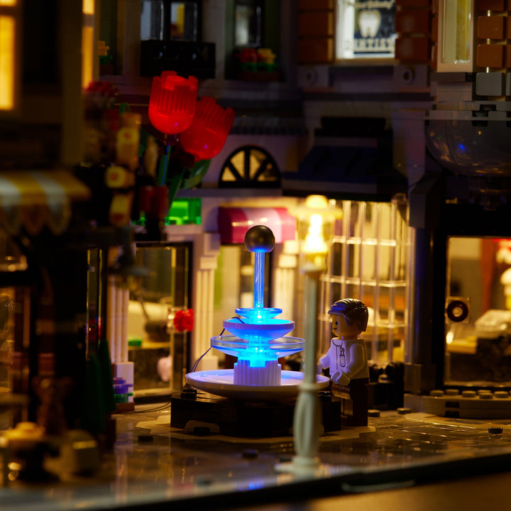 Close up of the fountain of the LEGO Assembly Square set 10255 with the Brick Loot LED Light Kit installed. Brilliant lights inside and out!