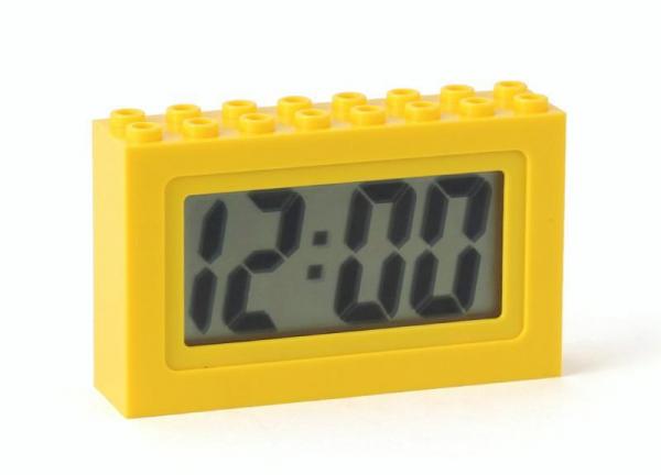 Small digital clock inside a bright yellow brick (LEGO inspired) case.  Sold by Brick Loot