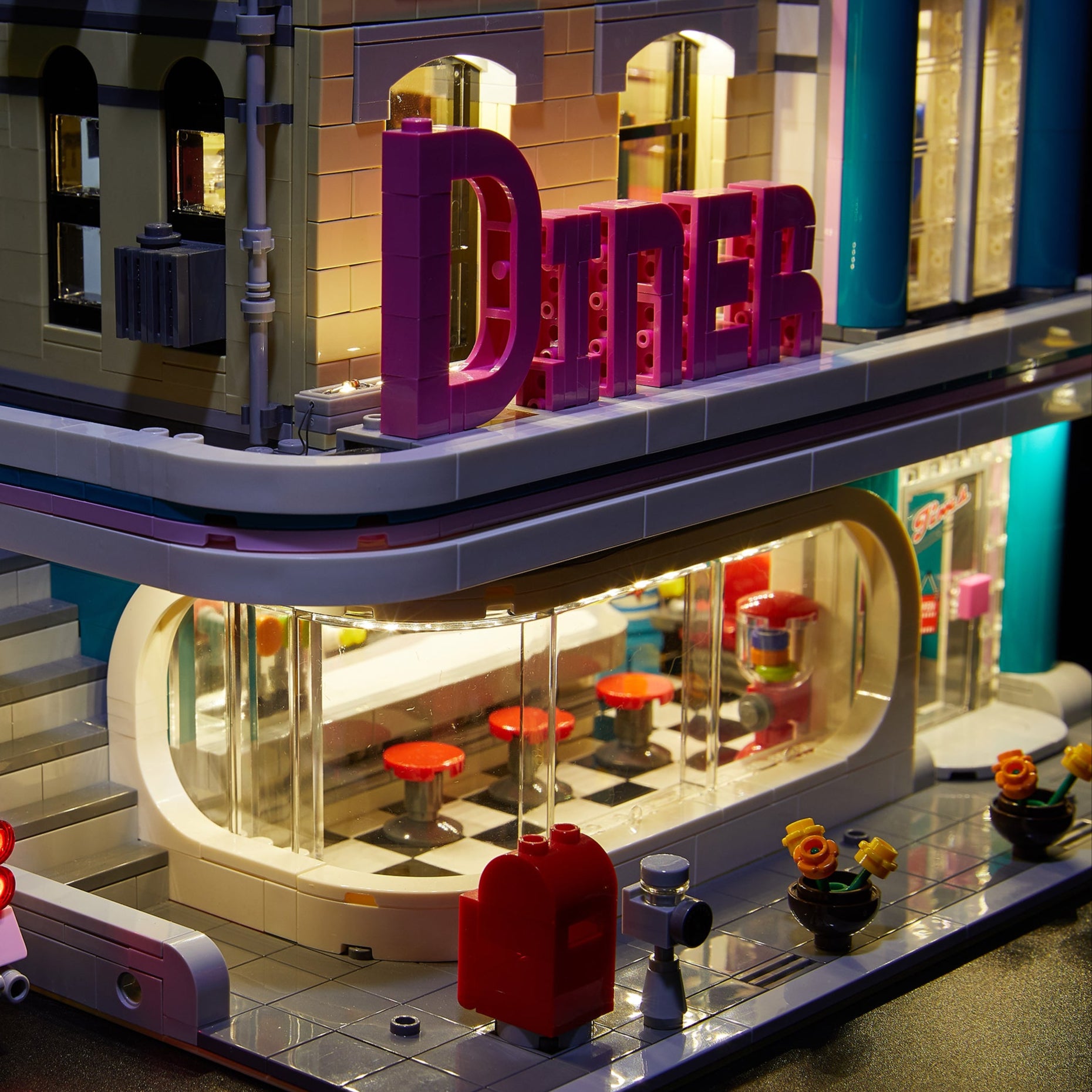 Close up of the LEGO Downtown Diner set 10260, brilliantly illuminated with the Brick Loot LED light kit! The Brick Loot light kit includes lights for the car!