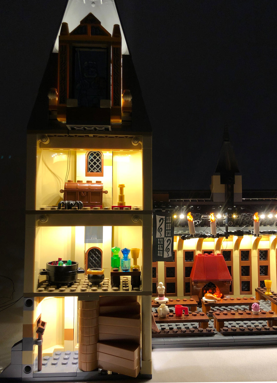 Close-up of the interior of the LEGO Hogwarts Great Hall set 75954, with the Brick Loot LED Light Kit.