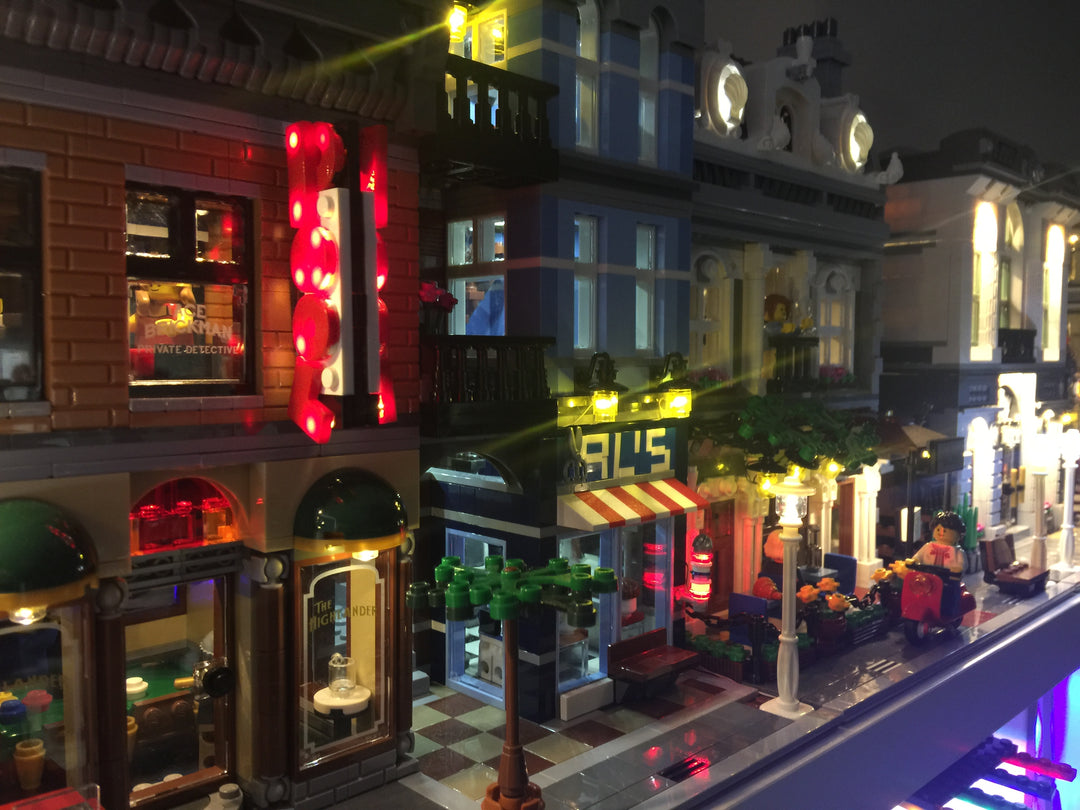 Close-up view of the custom Brick Loot light kit installed on the LEGO Detective's Office and Barbershop set 10246. The extra POOL sign and barbershop light are shown here.  