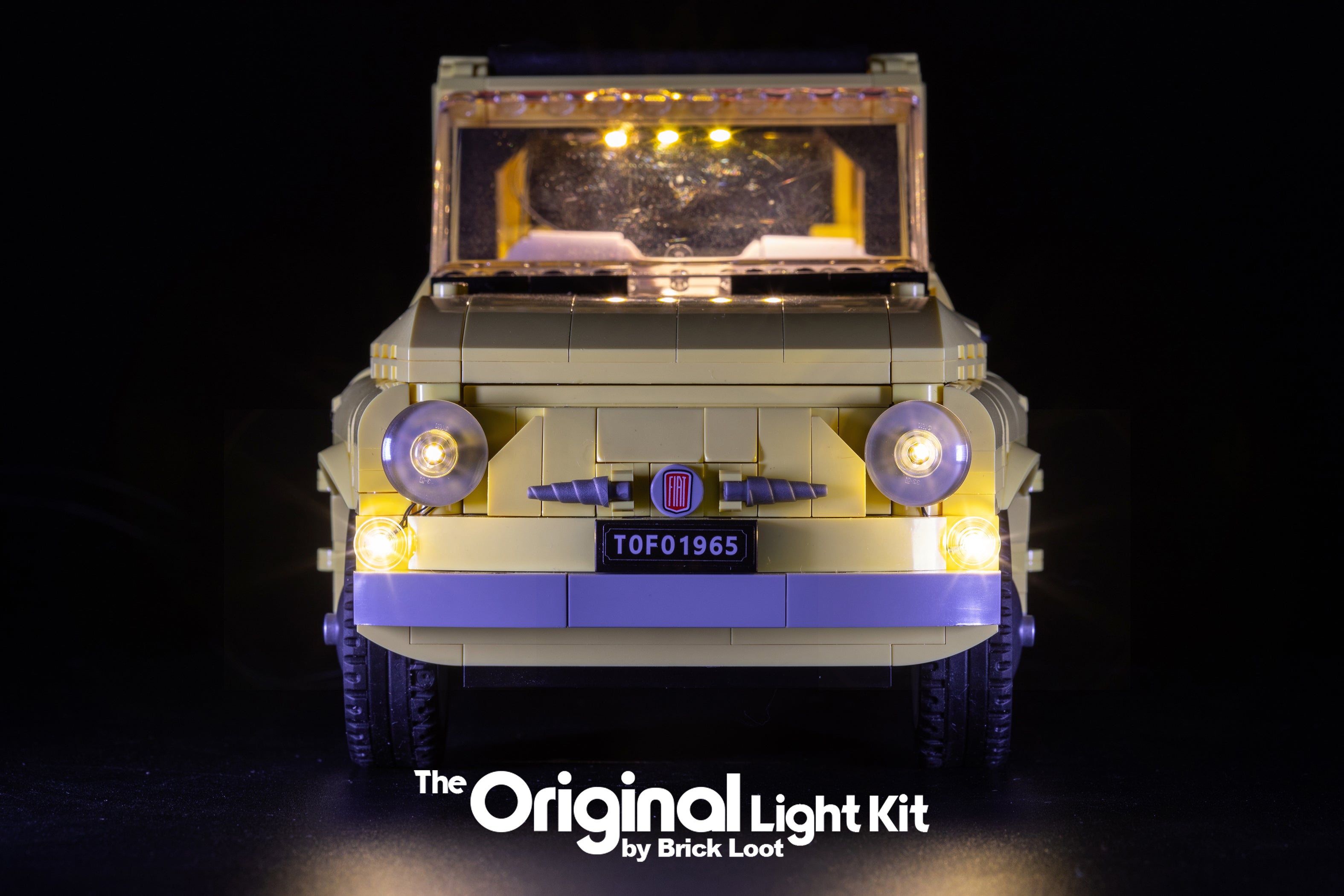 Close-up of the front of the LEGO Fiat 500 set 10271 with the custom Brick Loot LED Light kit installed. Brilliant LEDs illuminate the front  headlights, interior, and tail lights of the Fiat model.