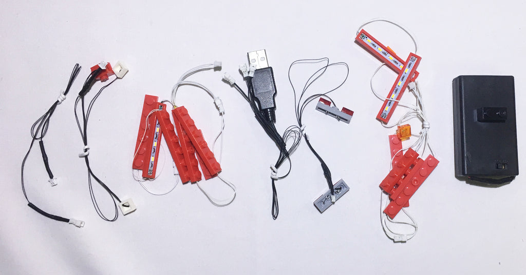 Handmade LED light strings, created by Brick Loot for the LEGO London bus set 10258. The light strings can be powered by a battery pack or USB (both shown here). The light strings easily connect to the power source with mini plugs. 