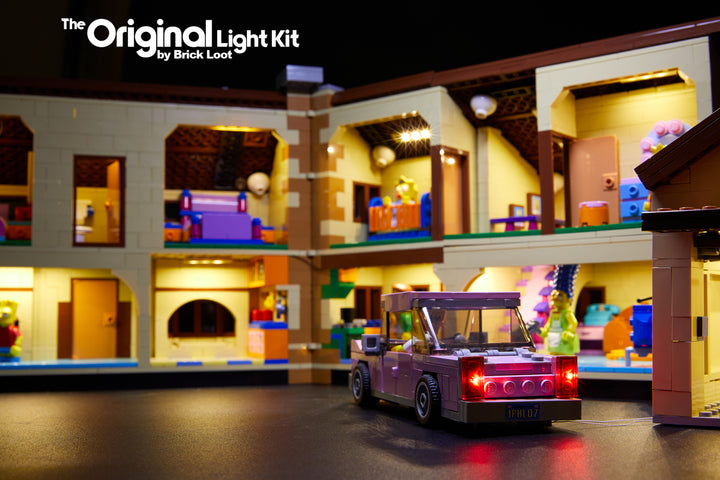 Close-up of the interior of the LEGO Simpsons House set 71006 with the Brick Loot LED Light Kit. All rooms, the garage, and the car are lit up with this custom-designed LED kit!
