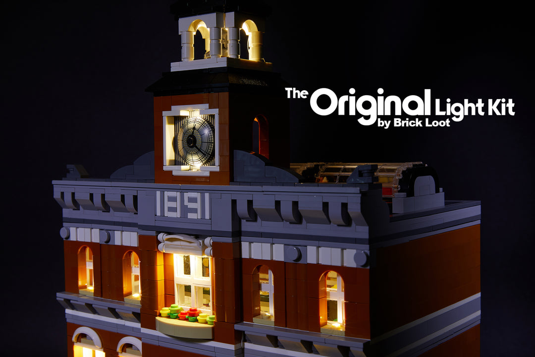 Close-up of the top of the LEGO Town Hall set 10224 with the interior and exterior lit up with the Brick Loot custom LED lighting kit.  Lights highlight the bell tower and clock!
