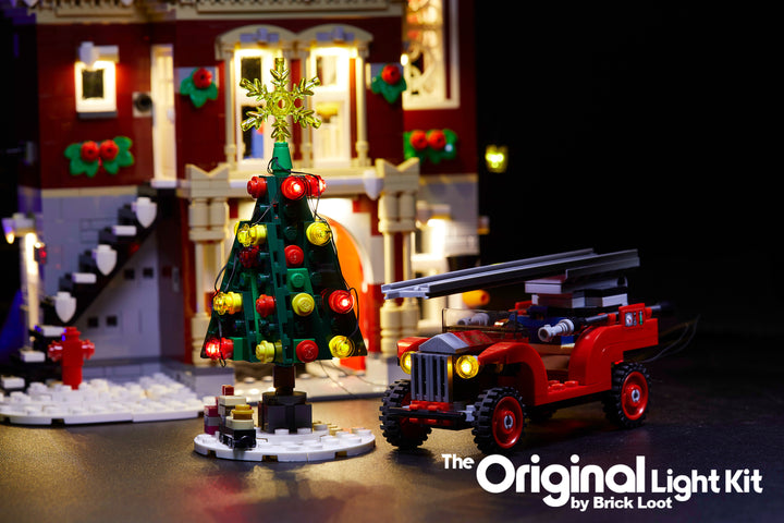 Close up of the  LEGO Winter Village Fire Station set, fully illuminated with the Brick Loot Custom LED Light kit! Beautiful LED lights light up the inside and outside of the Fire Station, Christmas tree, fire truck, and more!!